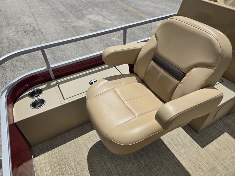 Slide: The Image of A beige captain's chair on a 2020 Lowe SF 232 pontoon boat, with cup holders beside it. - 13
