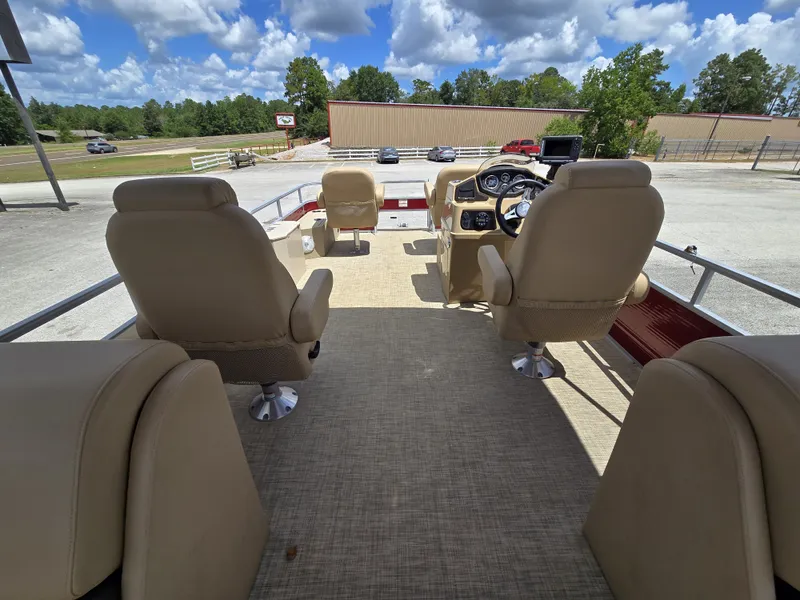 Slide: The Image of The image shows the cockpit of a 2020 Lowe SF 232 pontoon boat with beige seats. - 26