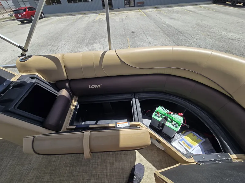 Slide: The Image of The image shows the interior of a 2020 Lowe SF 232 boat with seating and storage. - 25