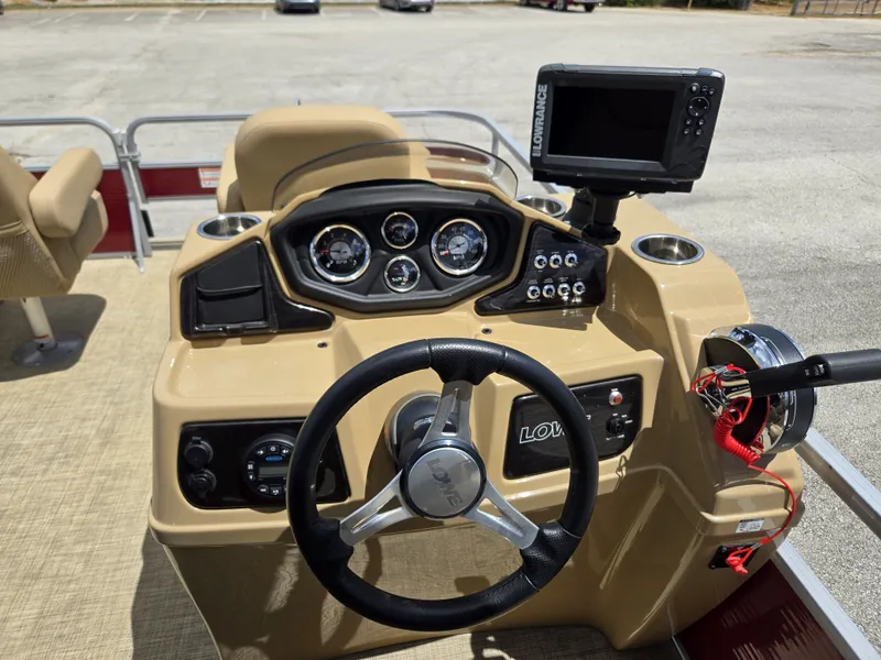 Slide: The Image of The image shows the helm of a 2020 Lowe SF 232 boat with a steering wheel and instruments. - 18