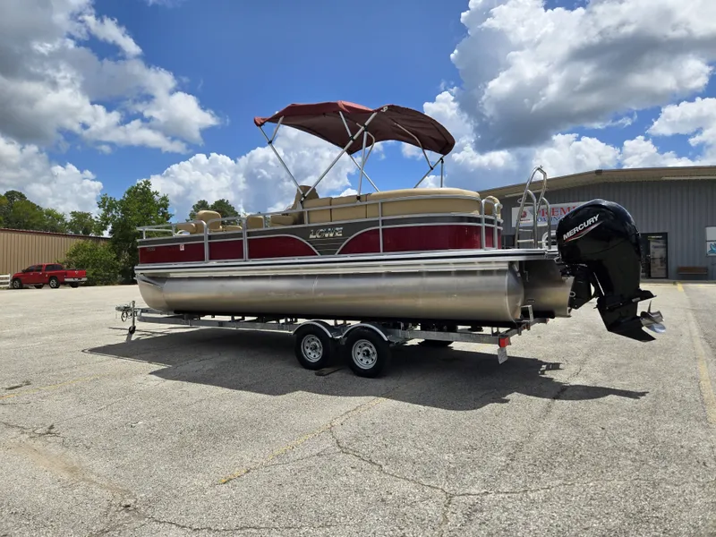 Slide: The Image of A 2020 Lowe SF 232 pontoon boat on a trailer in a parking lot. - 3