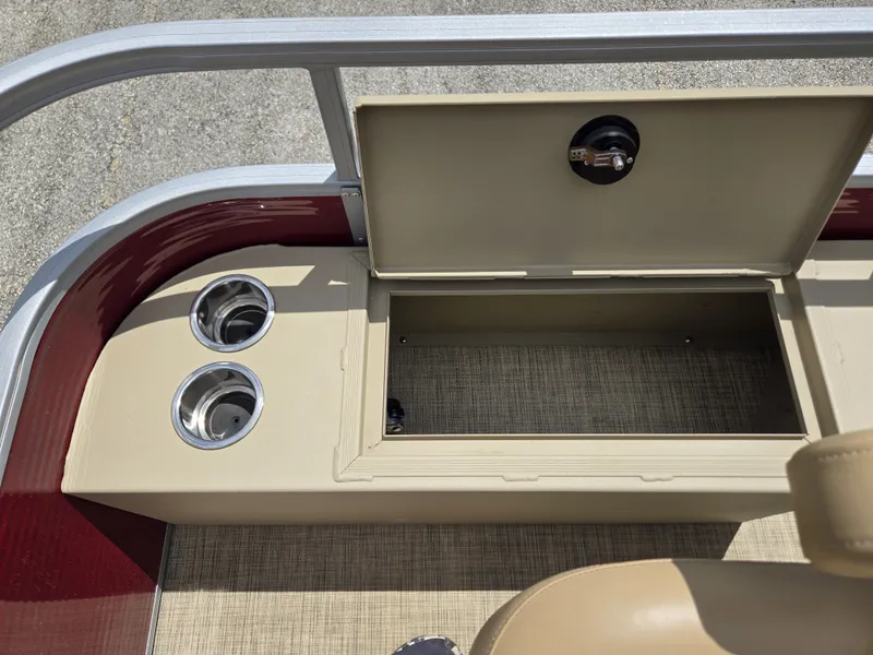 Slide: The Image of An open storage compartment on a 2020 Lowe SF 232 boat with two cup holders. - 14