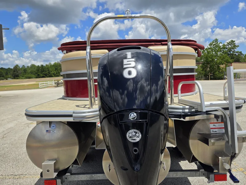 Slide: The Image of A 2020 Lowe SF 232 pontoon boat with a 150 HP engine, parked on a trailer. - 5