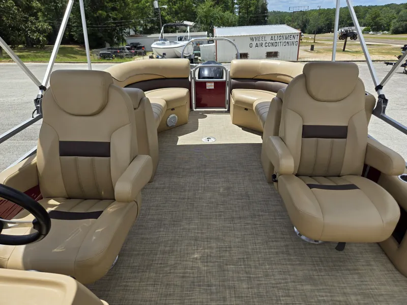 Slide: The Image of The image shows the interior of a 2020 Lowe SF 232 pontoon boat with beige leather seats. - 21