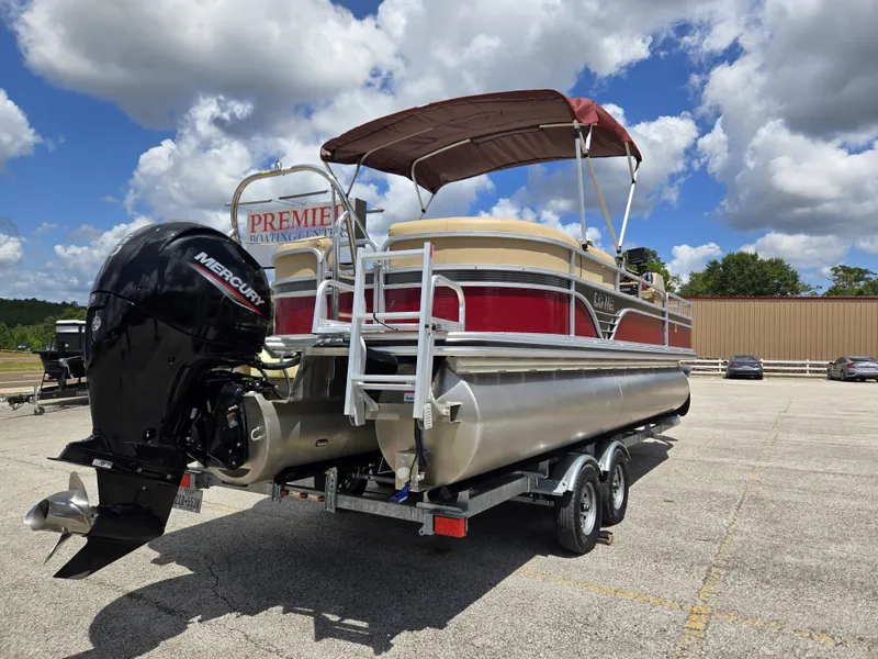 Slide: The Image of A 2020 Lowe SF 232 pontoon boat on a trailer under a blue sky. - 6