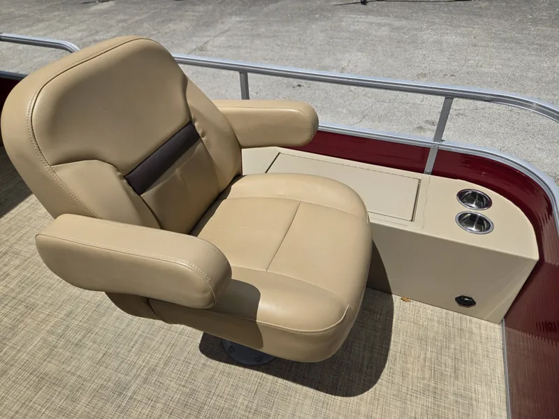 Slide: The Image of A beige captain's chair on a 2020 Lowe SF 232 pontoon boat, with cup holders beside it. - 12
