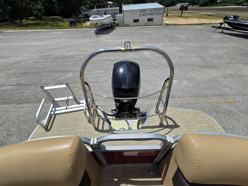 Slide: The Image of The image shows the rear of a Lowe SF 232 pontoon boat with an outboard motor. - 27