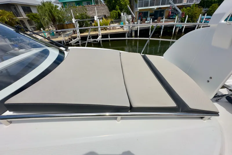 Slide: The Image of Sunpad on 2018 Jeanneau NC 895 boat, docked near waterfront homes. - 38
