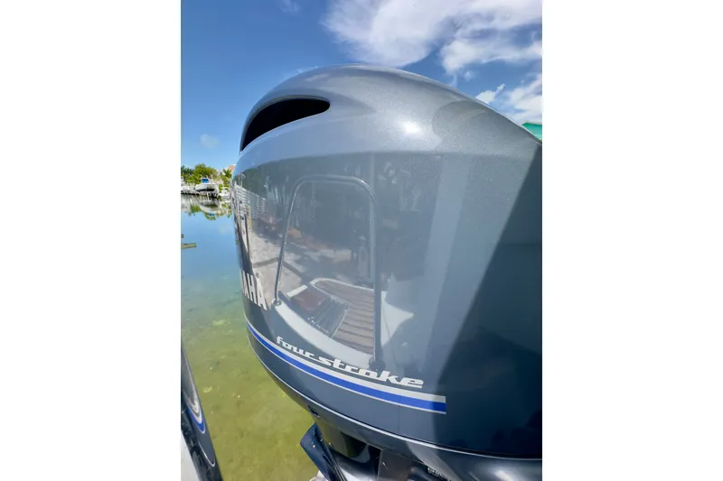 Slide: The Image of Yamaha four-stroke engine on a 2018 Jeanneau NC 895 boat, reflecting clear sky. - 42