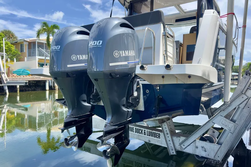 Slide: The Image of 2018 Jeanneau NC 895 with twin Yamaha 200 engines on a boat lift. - 47