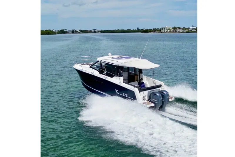 Slide: The Image of 2018 Jeanneau NC 895 cruising on open water under a clear blue sky. - 48