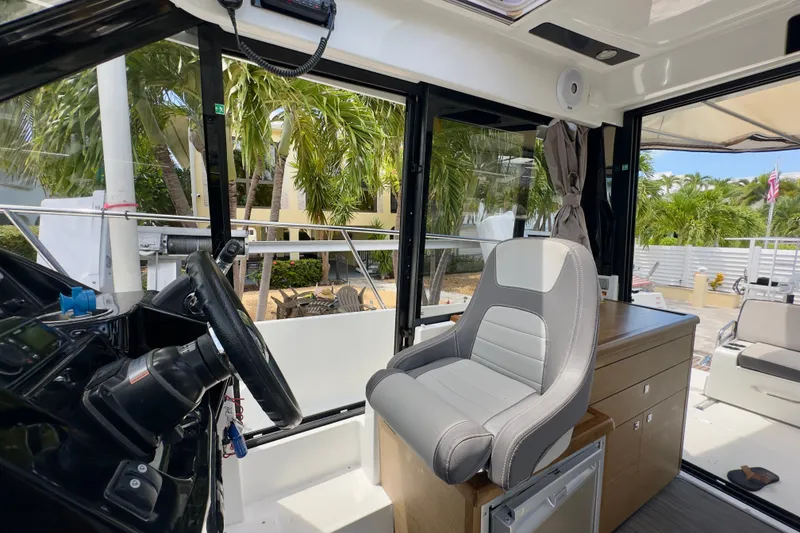 Slide: The Image of Interior of 2018 Jeanneau NC 895 boat with helm and seating area. - 36