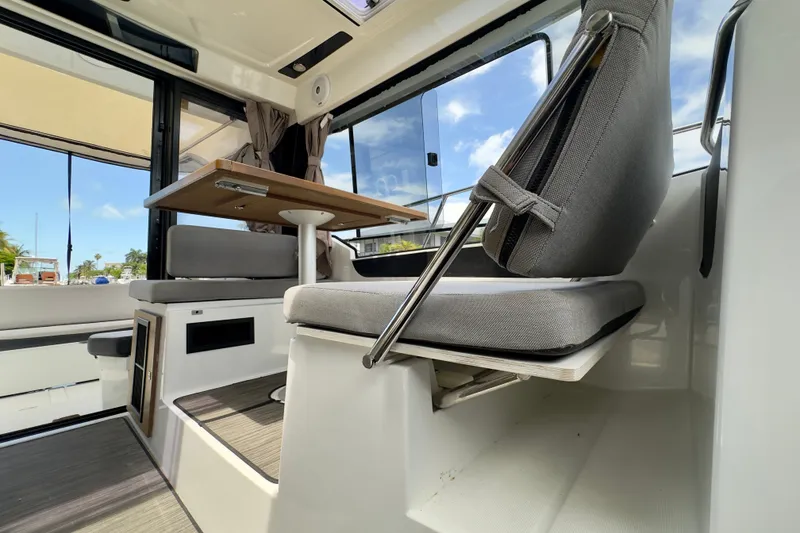Slide: The Image of Interior of 2018 Jeanneau NC 895 boat with seating and table, showcasing modern design. - 34