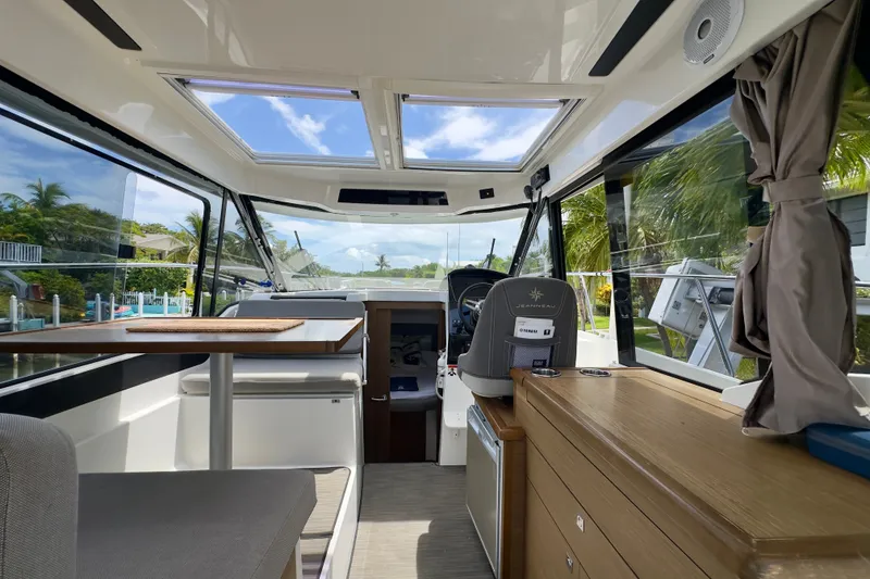 Slide: The Image of Interior of 2018 Jeanneau NC 895 boat with modern seating and panoramic windows. - 19