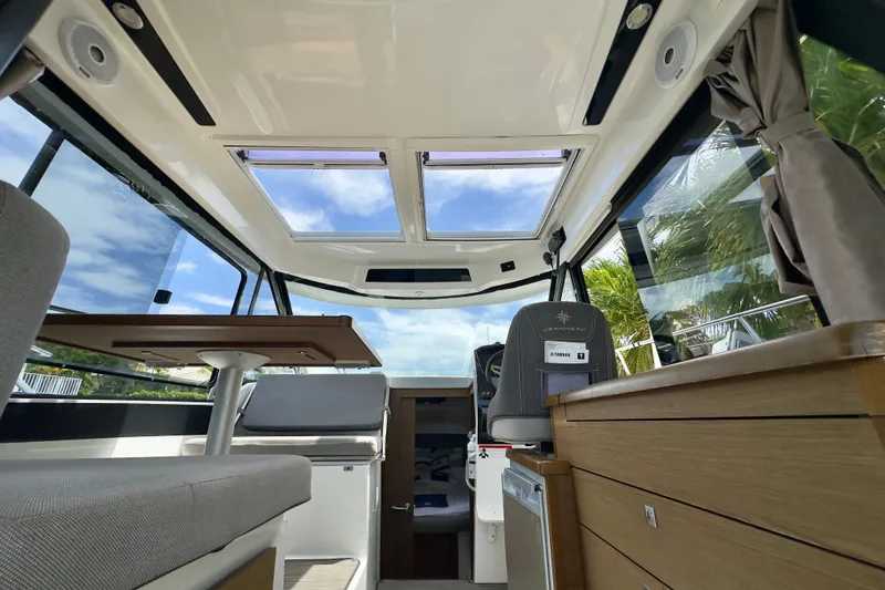 Slide: The Image of Interior of 2018 Jeanneau NC 895 boat with modern seating and panoramic windows. - 21