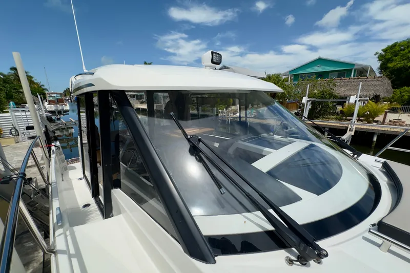 Slide: The Image of 2018 Jeanneau NC 895 boat docked, featuring sleek design and spacious cabin. - 41