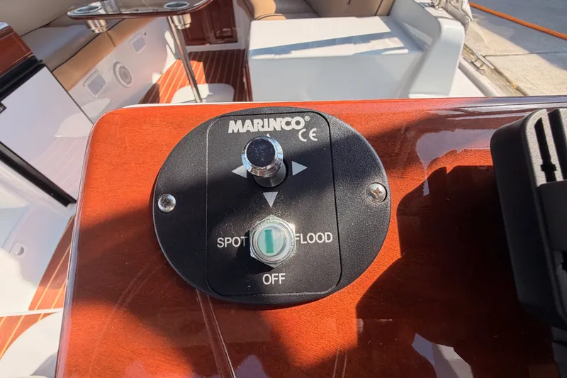 Slide: The Image of Control panel on a 2018 Duffy Cuddy Cabin 22 boat, featuring Marinco spotlight switch. - 30