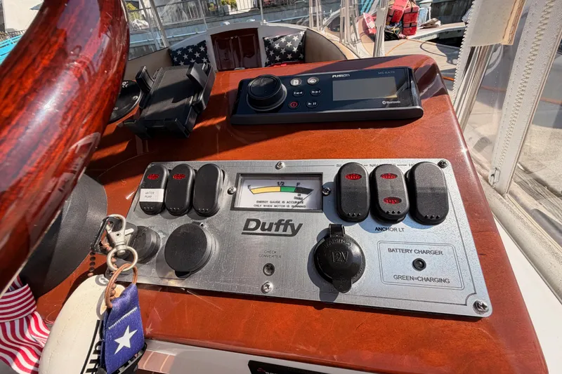 Slide: The Image of Control panel of a 2018 Duffy Cuddy Cabin 22 boat with steering wheel and switches. - 28