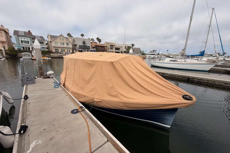 Slide: The Image of 2018 Duffy Cuddy Cabin 22 boat covered at marina dockside. - 33