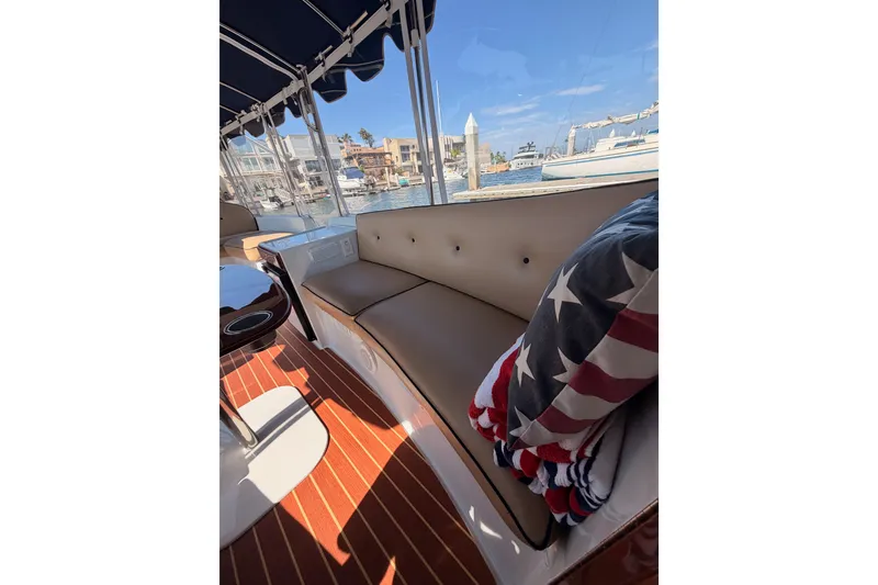 Slide: The Image of Interior of 2018 Duffy Cuddy Cabin 22 with American flag blanket, dockside view. - 16