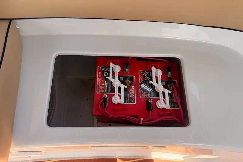 Slide: The Image of Battery compartment of a 2018 Duffy Cuddy Cabin 22 boat, featuring red marine batteries. - 43