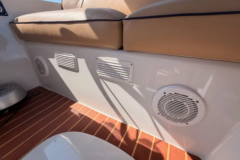 Slide: The Image of Interior of 2018 Duffy Cuddy Cabin 22 with tan seating and wood-patterned flooring. - 23