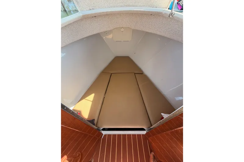 Slide: The Image of 2018 Duffy Cuddy Cabin 22 interior with beige cushions and wooden flooring. - 15