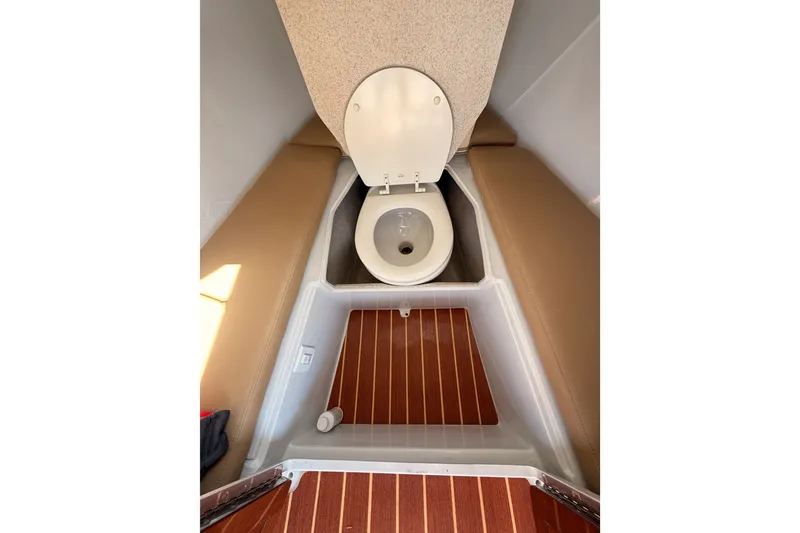 Slide: The Image of Interior of 2018 Duffy Cuddy Cabin 22 featuring a compact marine toilet. - 14