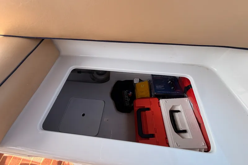 Slide: The Image of Storage compartment in a 2018 Duffy Cuddy Cabin 22 boat with various equipment. - 37