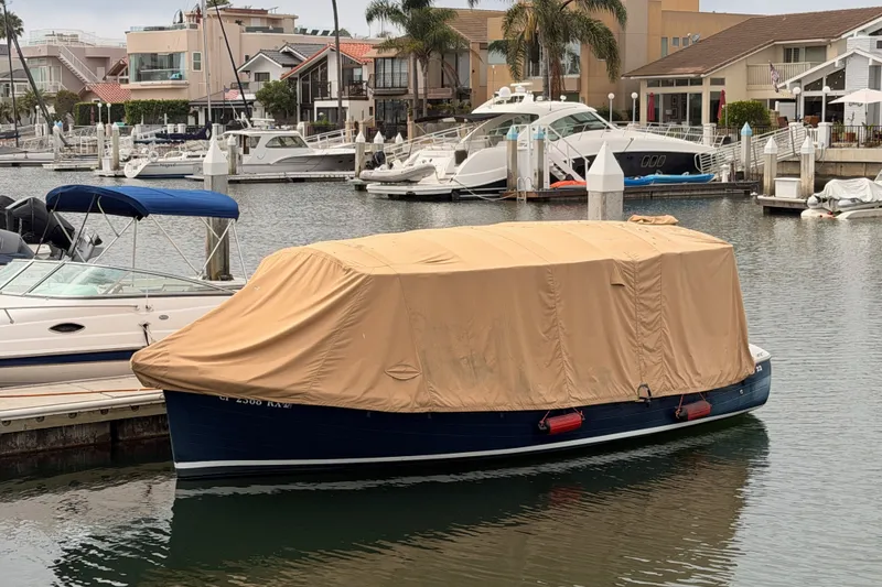 Slide: The Image of Covered 2018 Duffy Cuddy Cabin 22 boat docked in a marina. - 32
