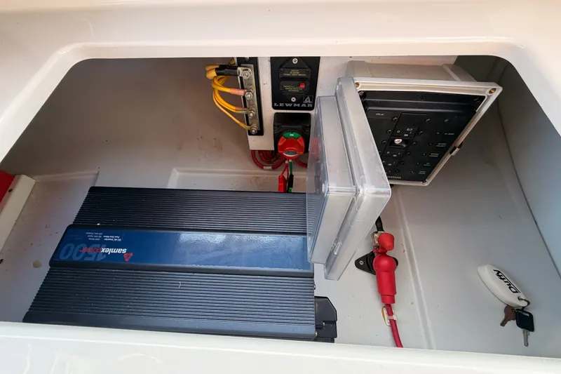 Slide: The Image of Electrical components inside a 2018 Duffy Cuddy Cabin 22 boat, featuring wiring and control panels. - 40