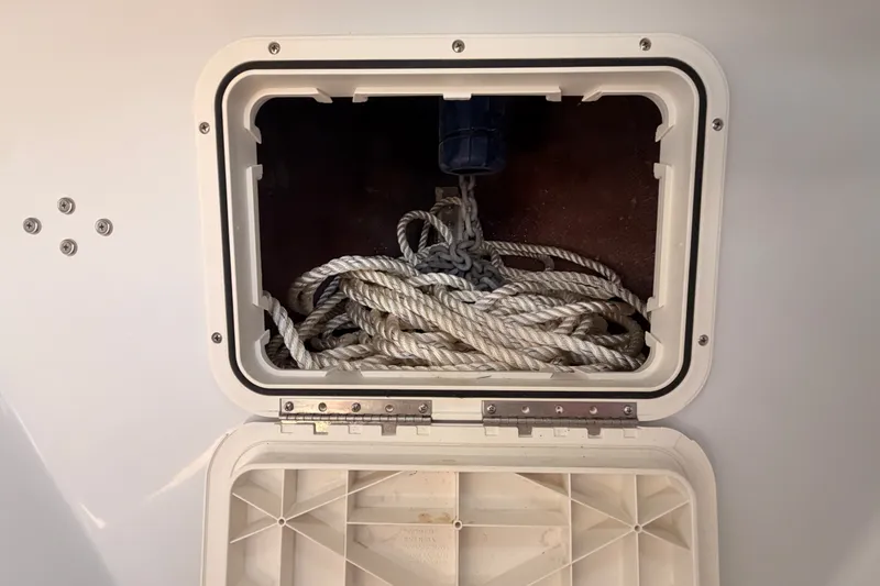 Slide: The Image of Storage compartment with coiled rope on a 2018 Duffy Cuddy Cabin 22 boat. - 34