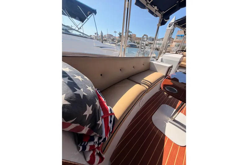 Slide: The Image of Interior of 2018 Duffy Cuddy Cabin 22 with cushioned seating and nautical decor. - 17