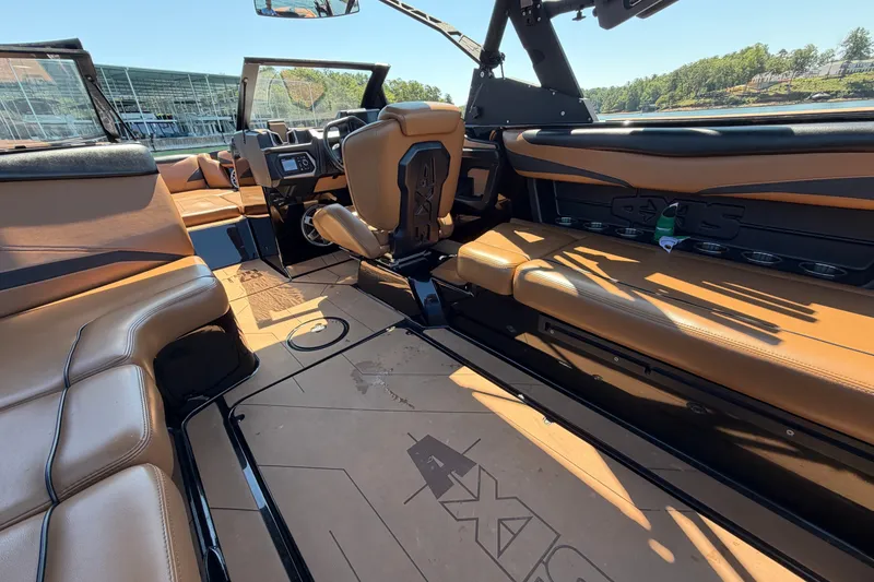 Slide: The Image of 2022 Axis T23 boat interior with tan leather seating and modern dashboard design. - 21