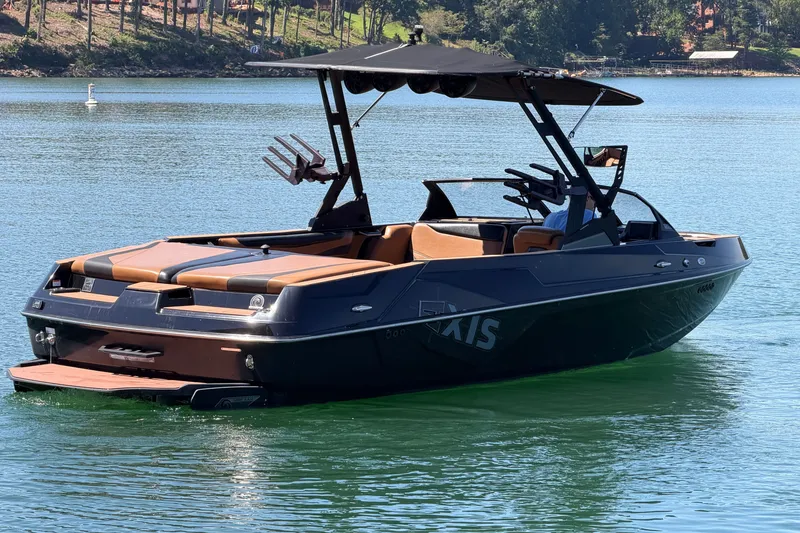 Slide: The Image of 2022 Axis T23 boat on a serene lake, featuring sleek design and modern amenities. - 6