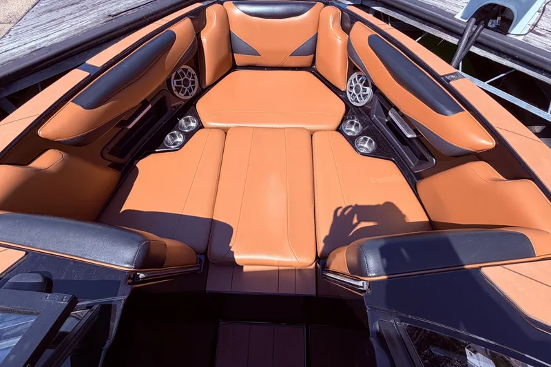 Slide: The Image of 2022 Axis T23 boat interior with tan leather seating and built-in speakers. - 25