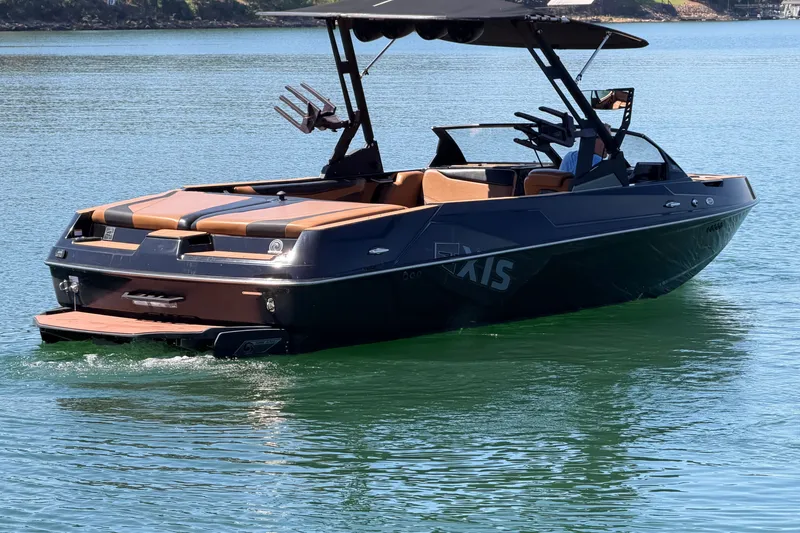 Slide: The Image of 2022 Axis T23 boat on calm water, featuring sleek design and comfortable seating. - 5