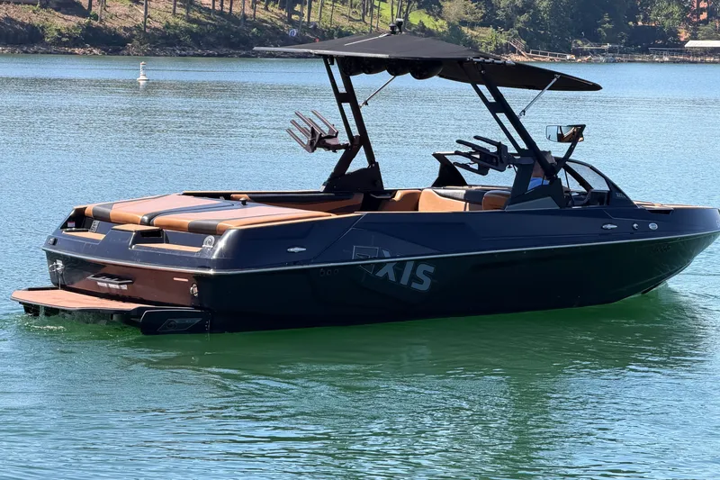 Slide: The Image of 2022 Axis T23 boat on a serene lake, featuring sleek design and modern amenities. - 7
