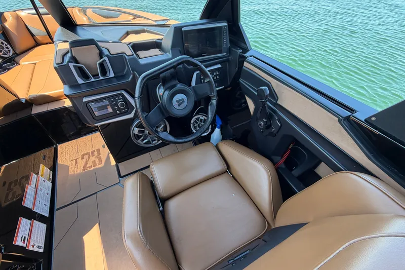 Slide: The Image of Interior of 2022 Axis T23 boat with tan seats and modern dashboard controls. - 19