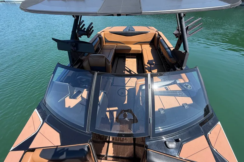 Slide: The Image of 2022 Axis T23 boat with sleek design, spacious seating, and modern features on calm water. - 22