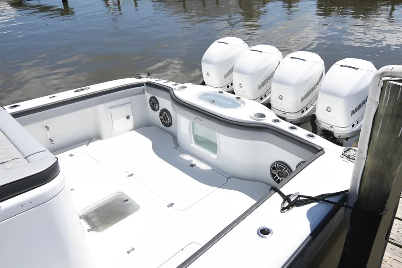 Slide: The Image of 2018 Yellowfin 39 Offshore boat with multiple Mercury outboard engines docked by the water. - 13