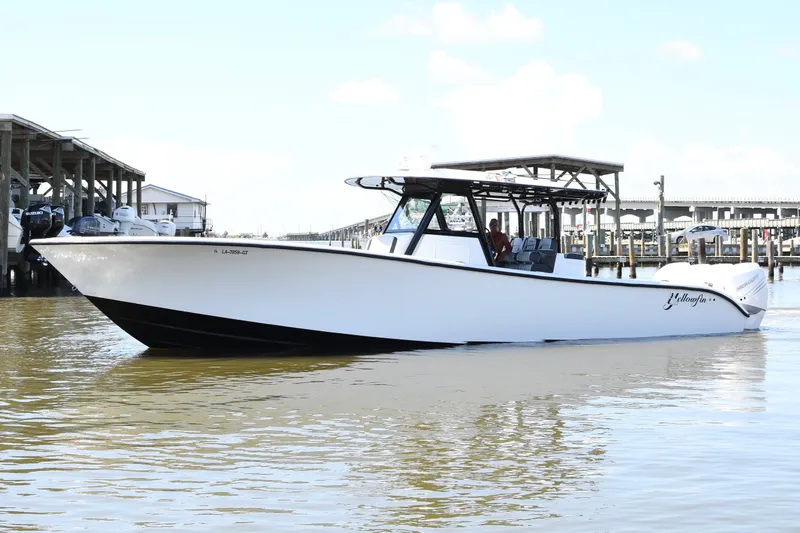 The Image of 2018 Yellowfin 39 Offshore boat docked in marina, showcasing sleek design and spacious deck. - 0