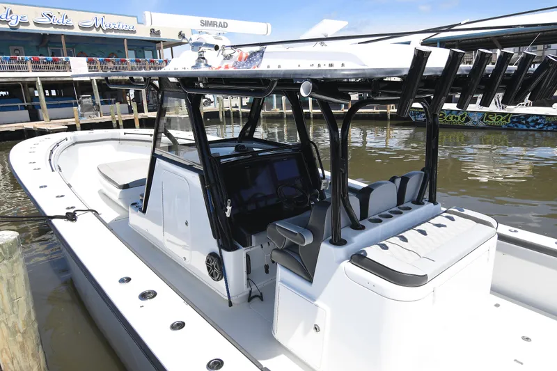 Slide: The Image of 2018 Yellowfin 39 Offshore boat docked at marina, featuring sleek design and advanced navigation equipment. - 15