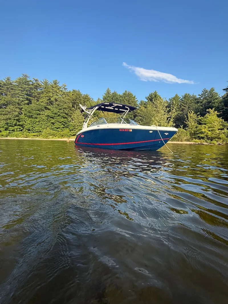 Slide: The Image of A 2021 Cobalt R3 boat floats on calm water near a wooded shoreline. - 5