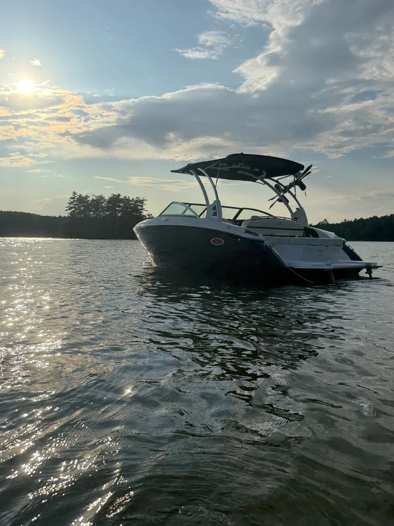 Slide: The Image of A 2021 Cobalt R3 boat floats on a calm lake at sunset. - 8