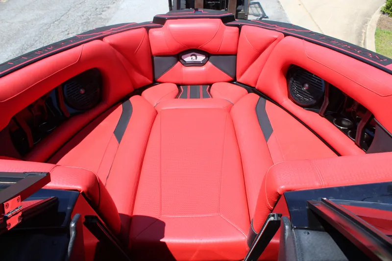 Slide: The Image of The image shows the red interior of a 2022 Centurion Ri 265 boat with black accents. - 16