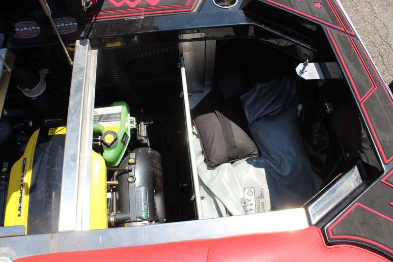 Slide: The Image of A view into the engine compartment of a 2022 Centurion Ri 265 with a yellow engine. - 22