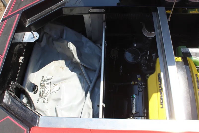 Slide: The Image of The engine compartment of a 2022 Centurion Ri 265 shows a yellow engine and covers. - 21