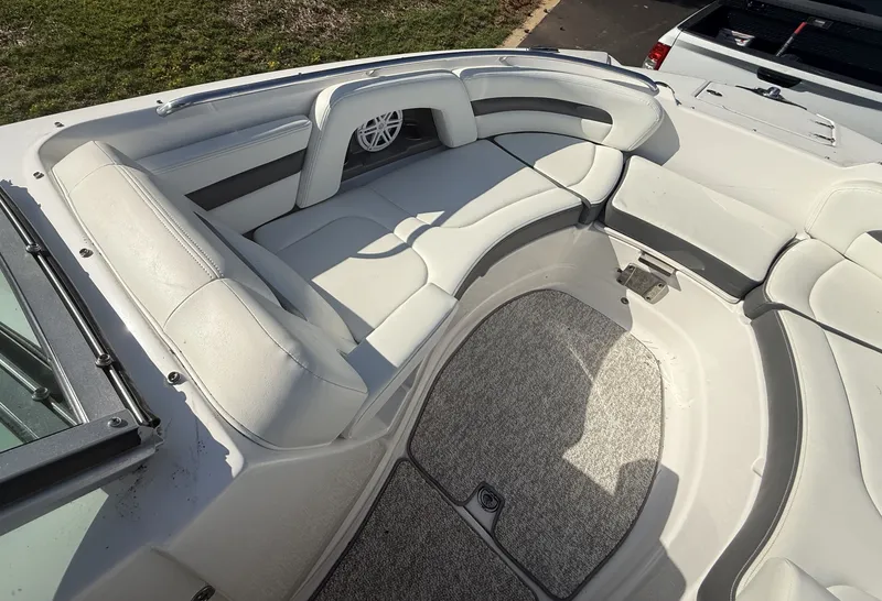 Slide: The Image of The image shows the bow area of a 2013 Chaparral 264 Sunesta with cushioned seating. - 17