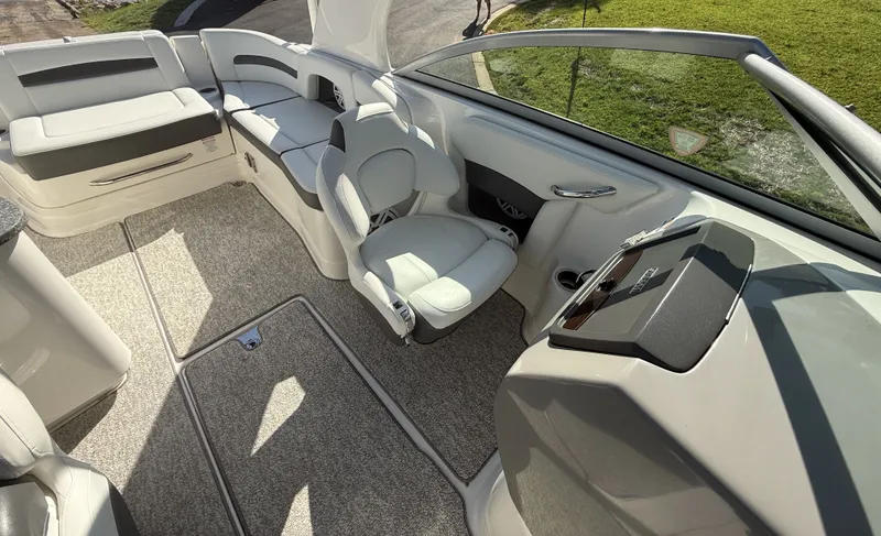 Slide: The Image of The image shows the cockpit of a 2013 Chaparral 264 Sunesta boat with comfortable seating. - 16